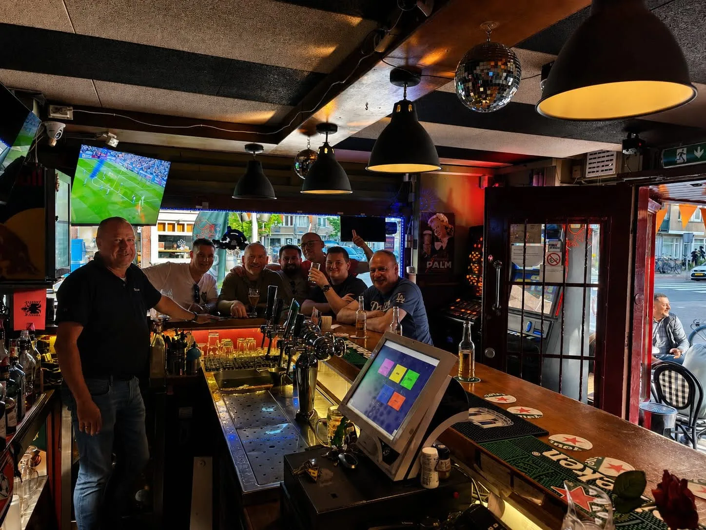 Friends and staff gathered inside The Magpie bar in Amsterdam