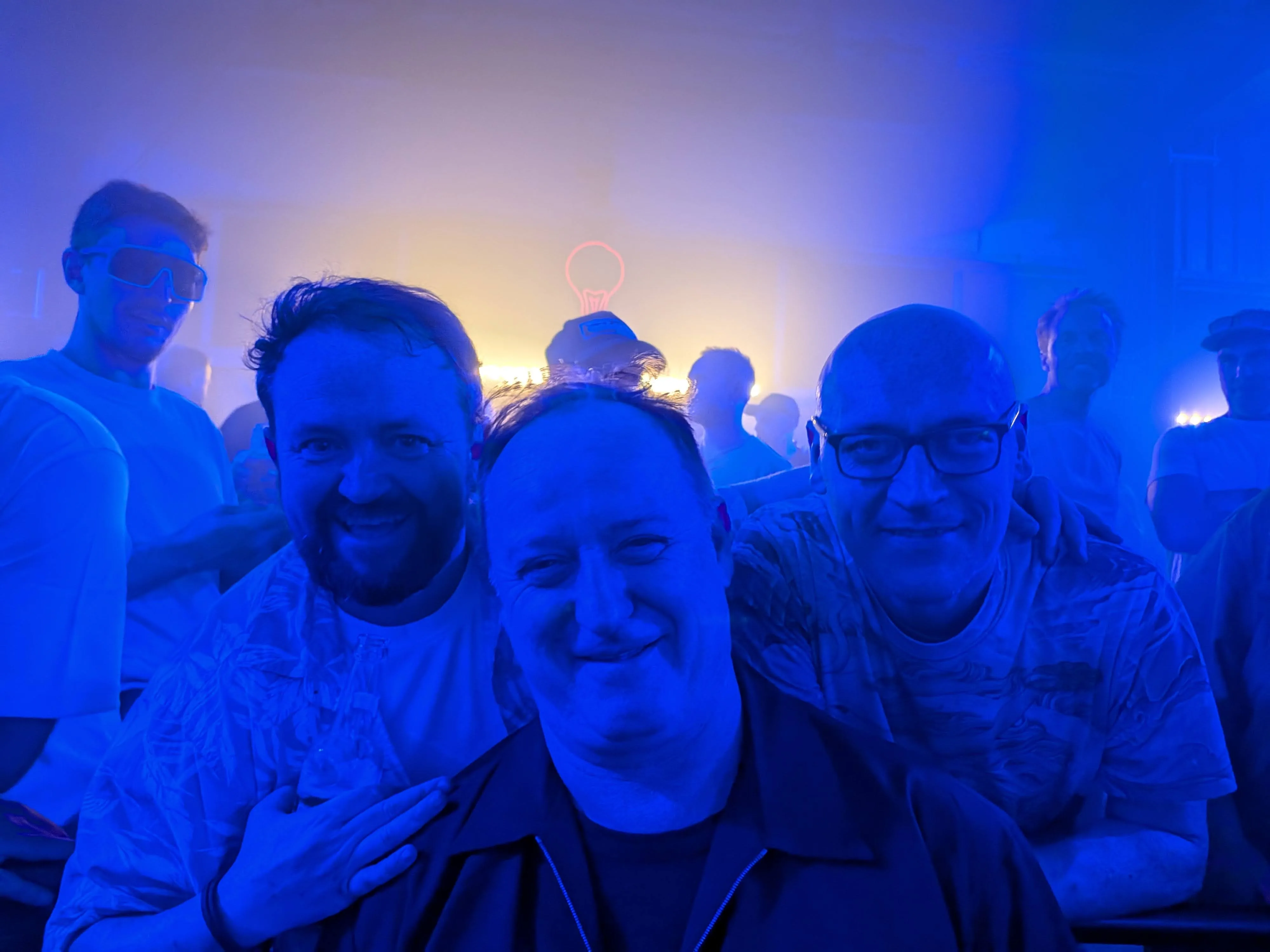 The group in blue nightclub lighting with alleged DJ Slippy Joe
